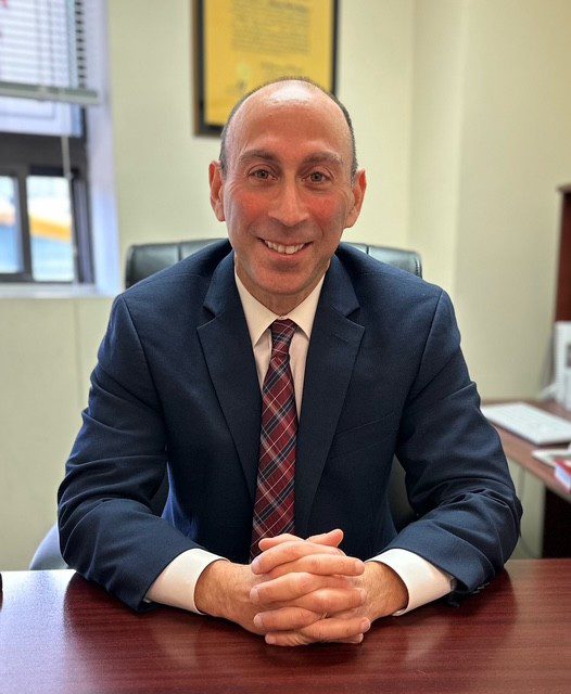 Man in suit sitting at desk